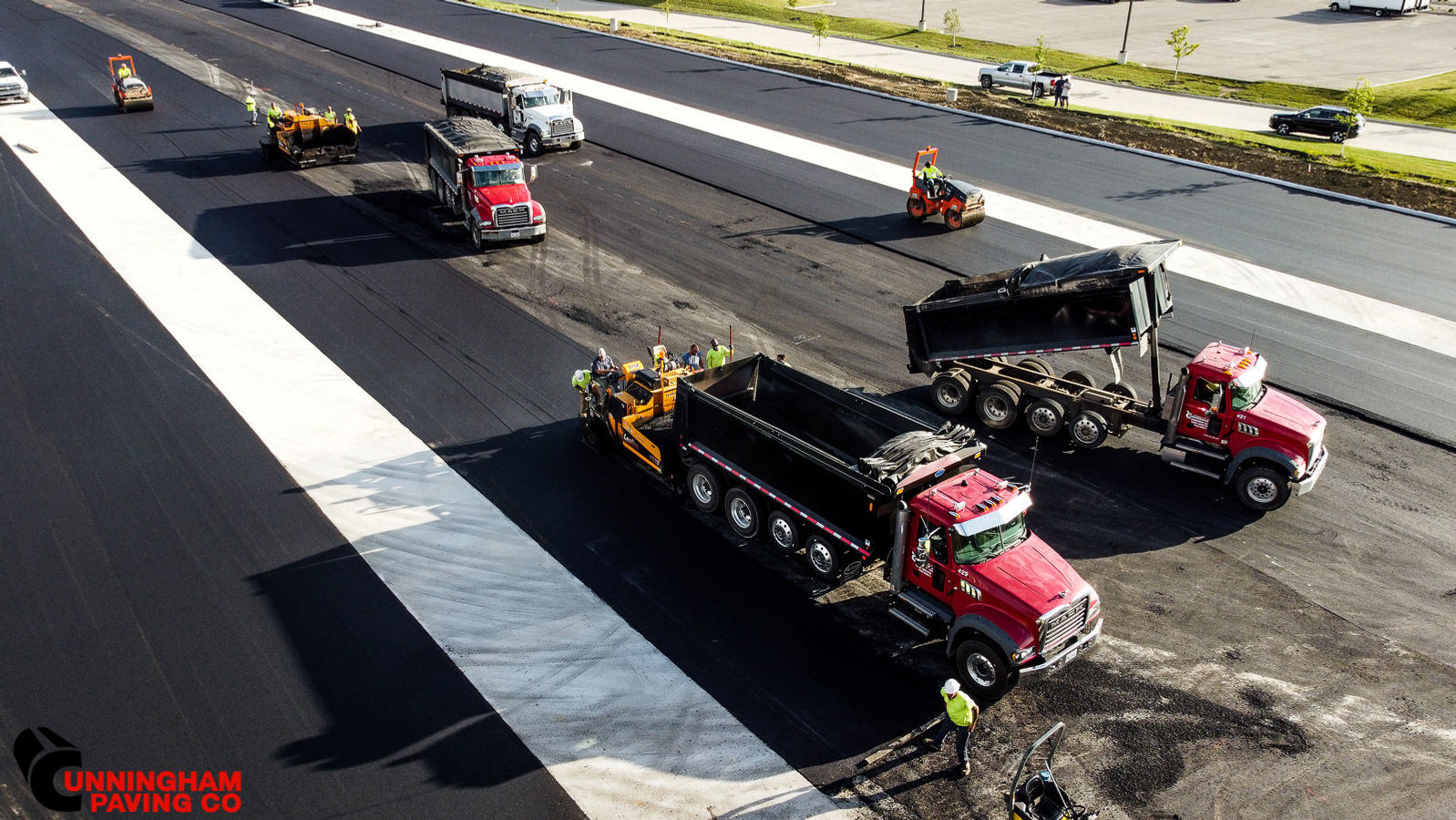 a group of trucks are driving down a highway