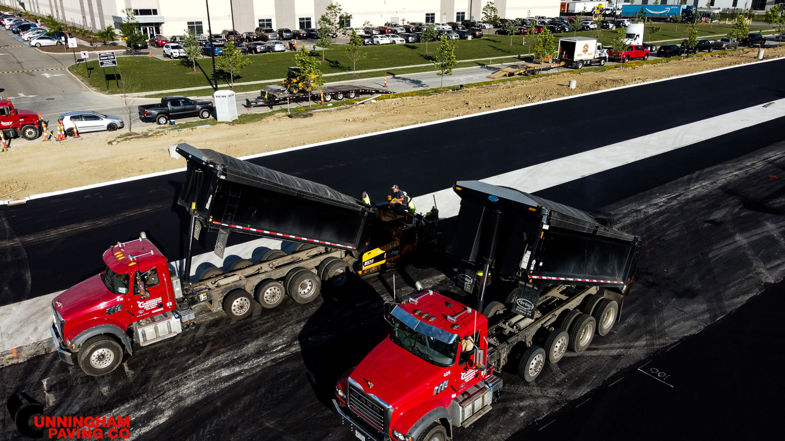 a couple of trucks are driving down a road