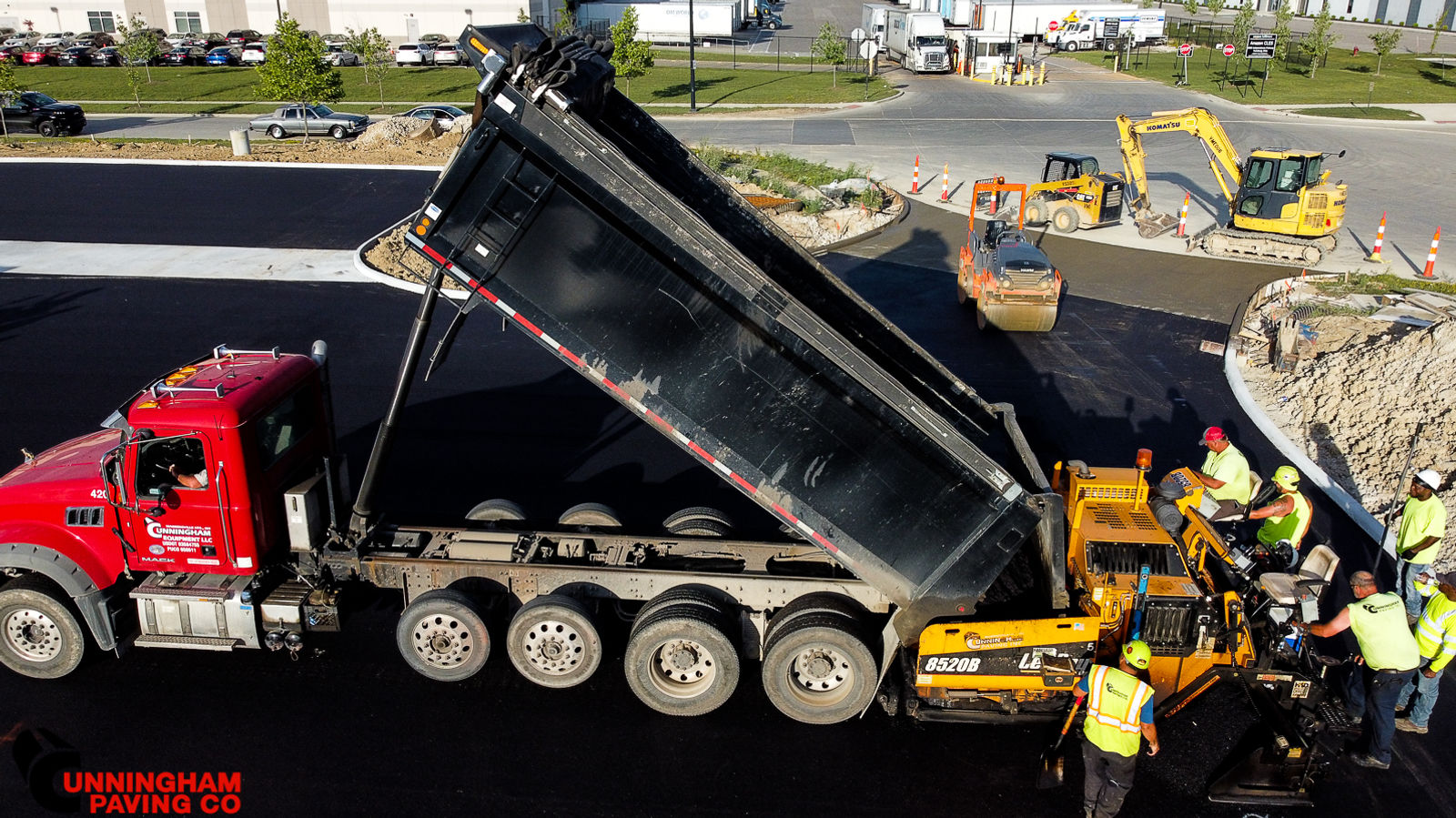 a dump truck is being loaded with asphalt at a construction site