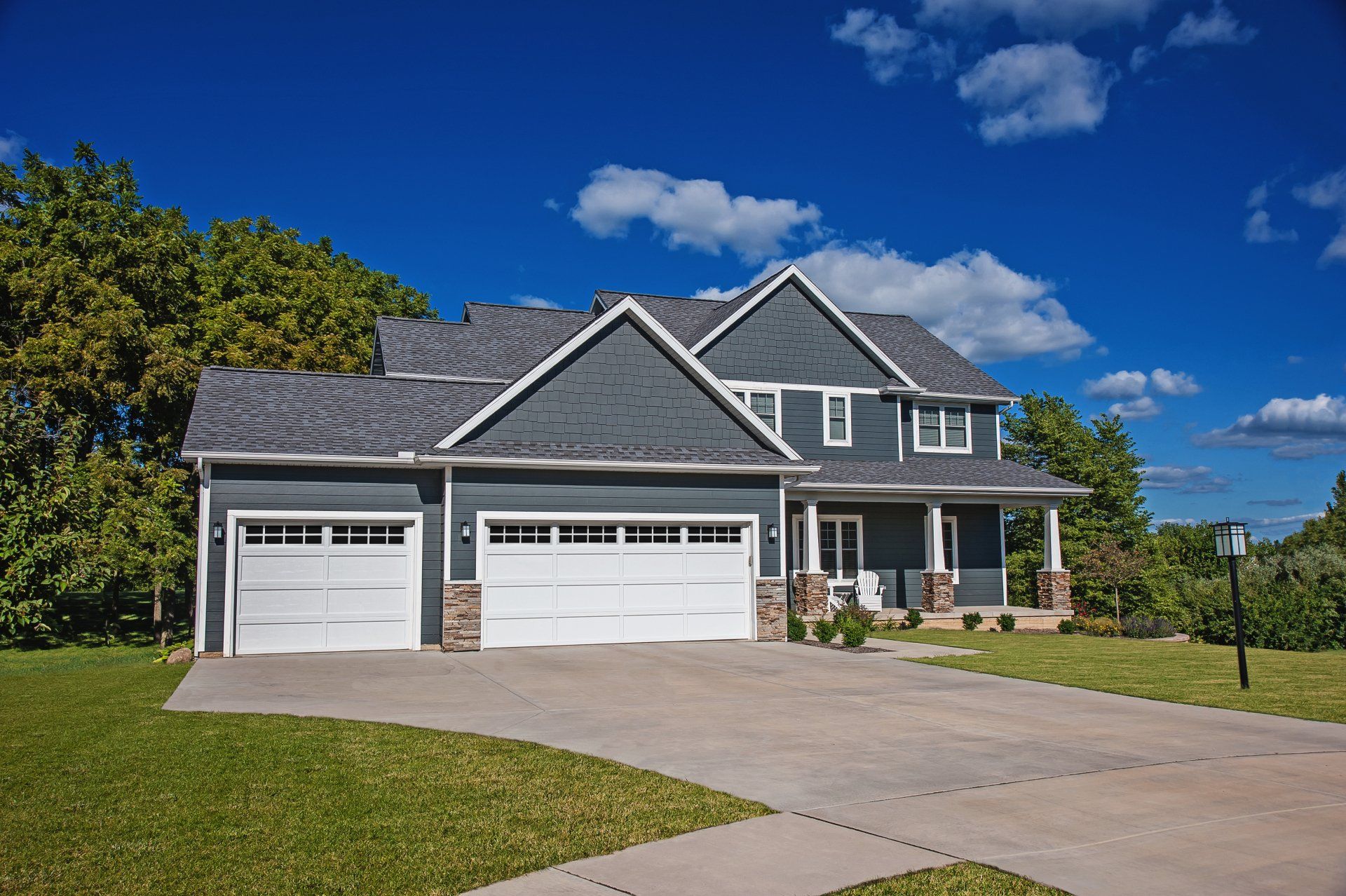 Residential house with white garage doors