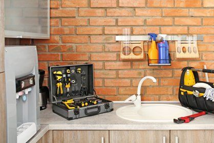 Set of plumber's tools near sink