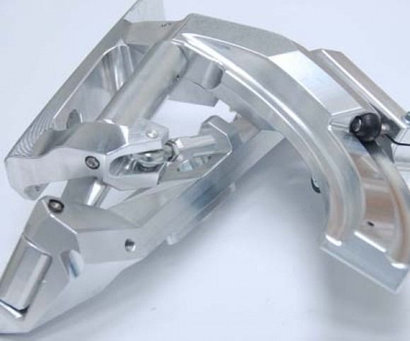 Silver metal bicycle brake calipers on a light background