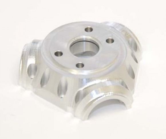 Transparent acrylic mechanical block with circular holes and a central bore, shown on a white background