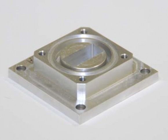 Metal mounting plate with a clear circular lens centered on a square base, shown on a white background