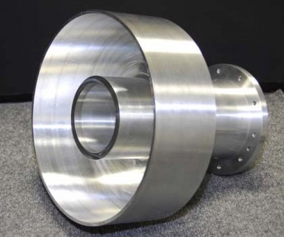 Machined metal cylindrical component with a brushed silver finish on a dark surface
