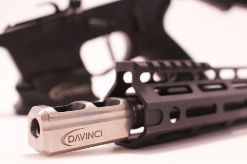 Close-up of a silver Davinci firearm barrel with a black handguard on a white background