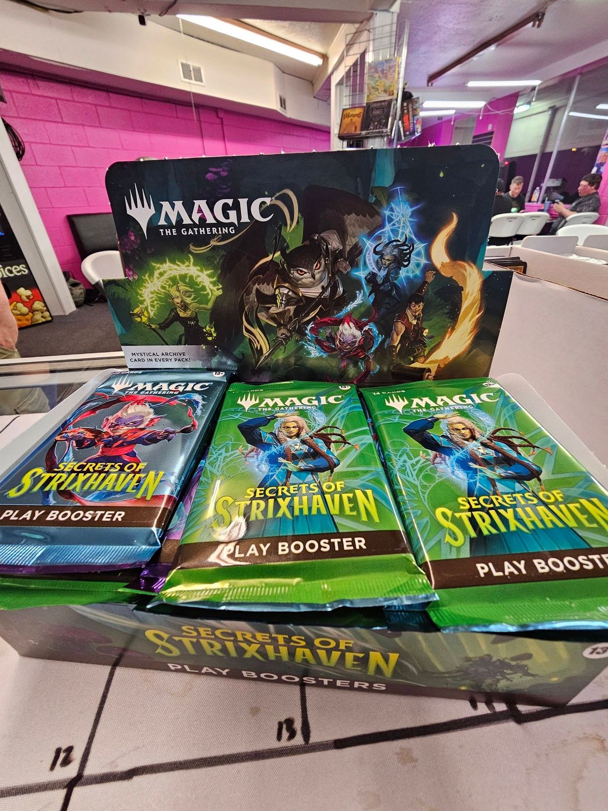 Fantasy characters casting magic spells, featuring a large winged owl-creature, against a dark green backdrop.