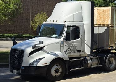 A white semi-truck is parked on a street