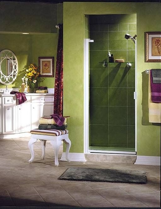 Green bathroom with shower, vanity, and accent decor.