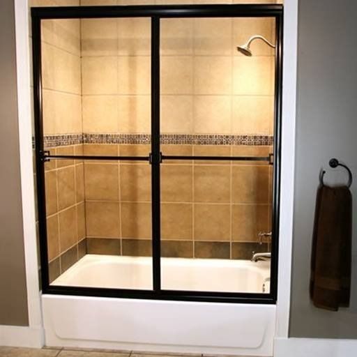 Black-framed sliding shower doors installed over a white bathtub in a tiled bathroom. A towel hangs on the wall.