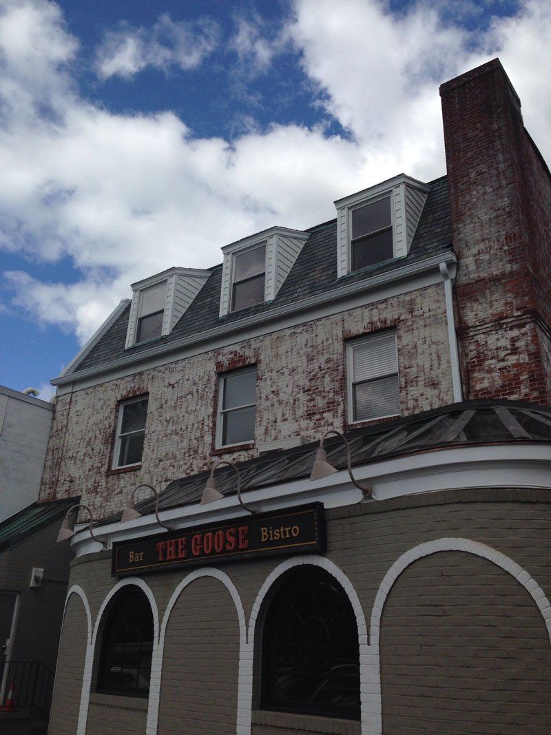 A large brick building with arches and a sign that says the frost pub