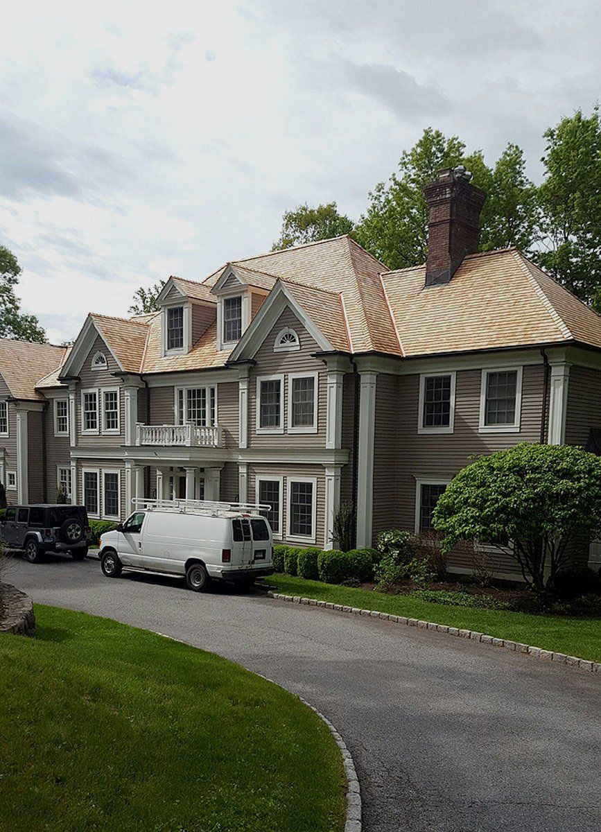 A large house with a white van parked in front of it