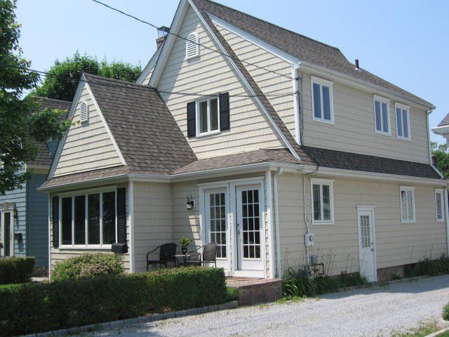 A house with a lot of windows and a driveway