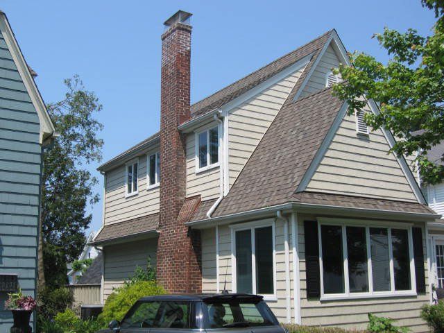 A house with a car parked in front of it