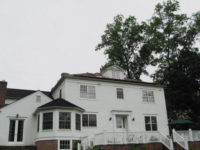 A large white house with a black roof