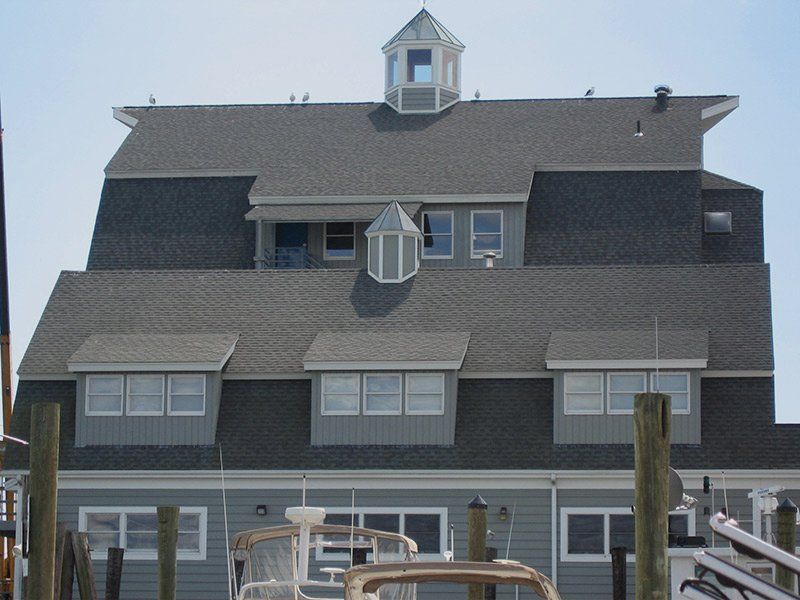 A large house with a roof that has a cupola on top