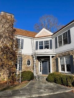 A large house with a ladder on the side of it