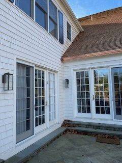 A white house with a patio and sliding glass doors