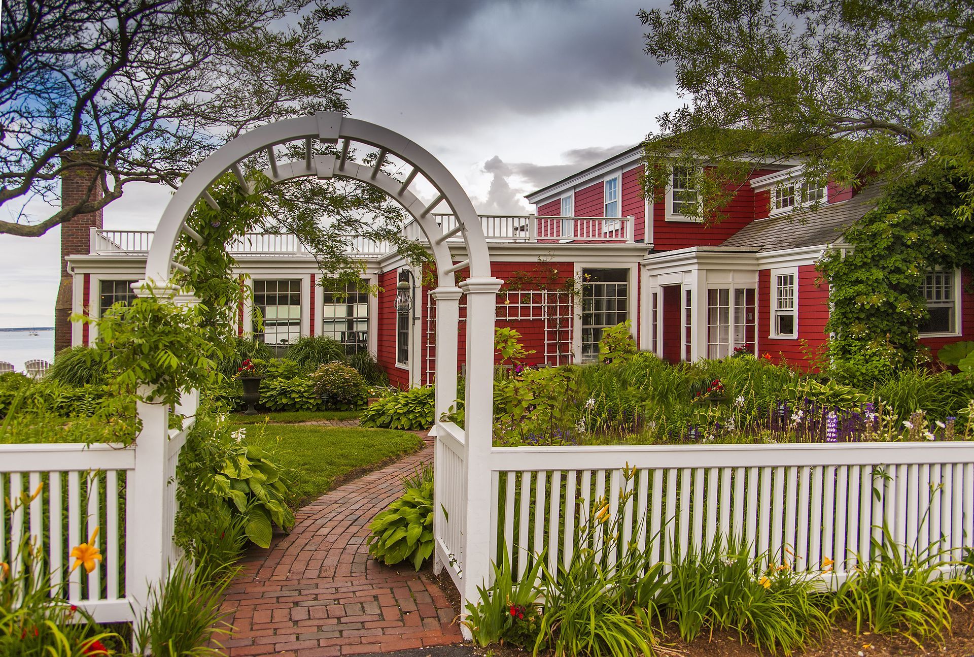 Modern, vacant commercial building with large windows and orange accents; blue sky.