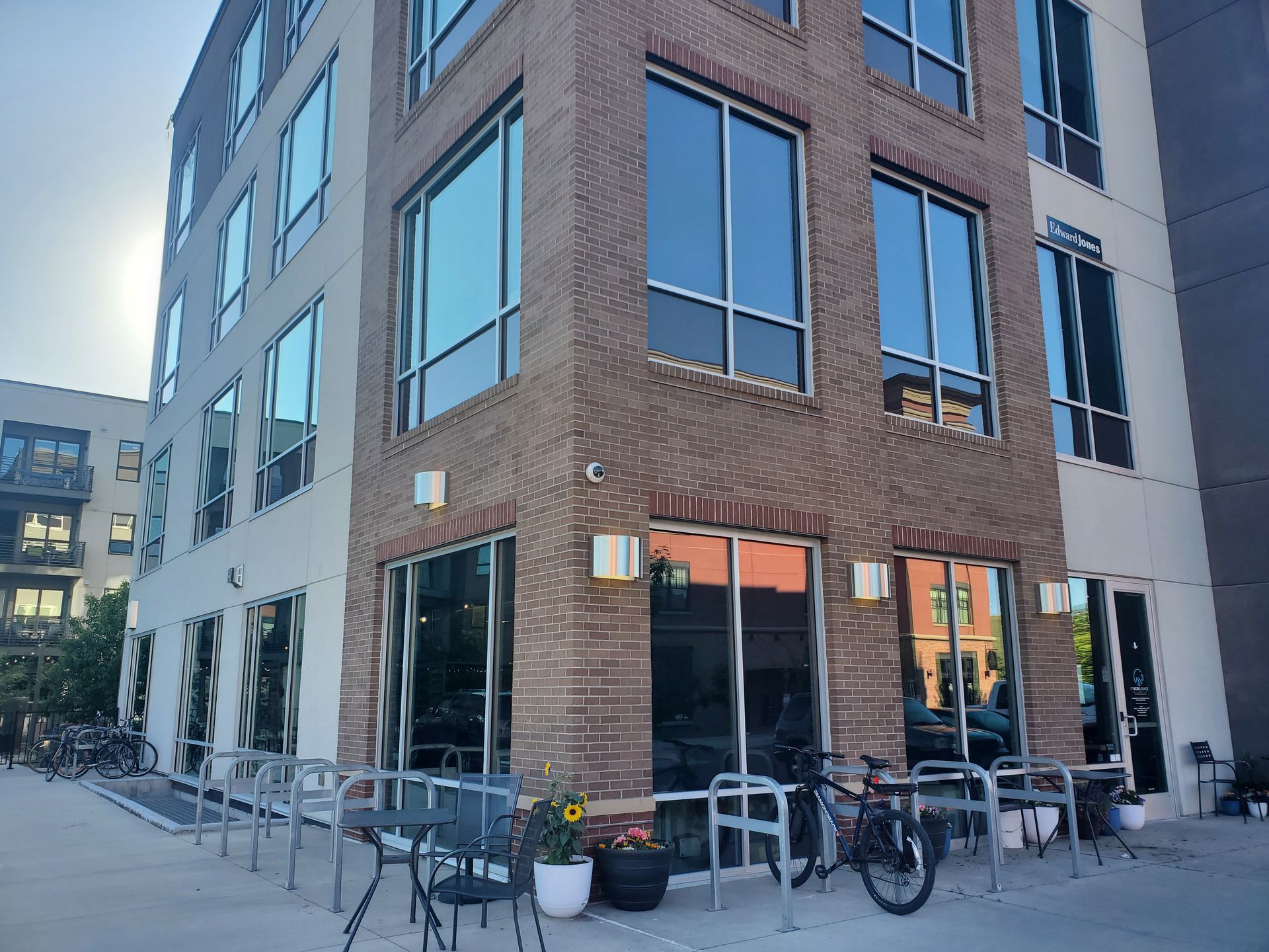 A large building with a lot of windows and a bicycle parked in front of it