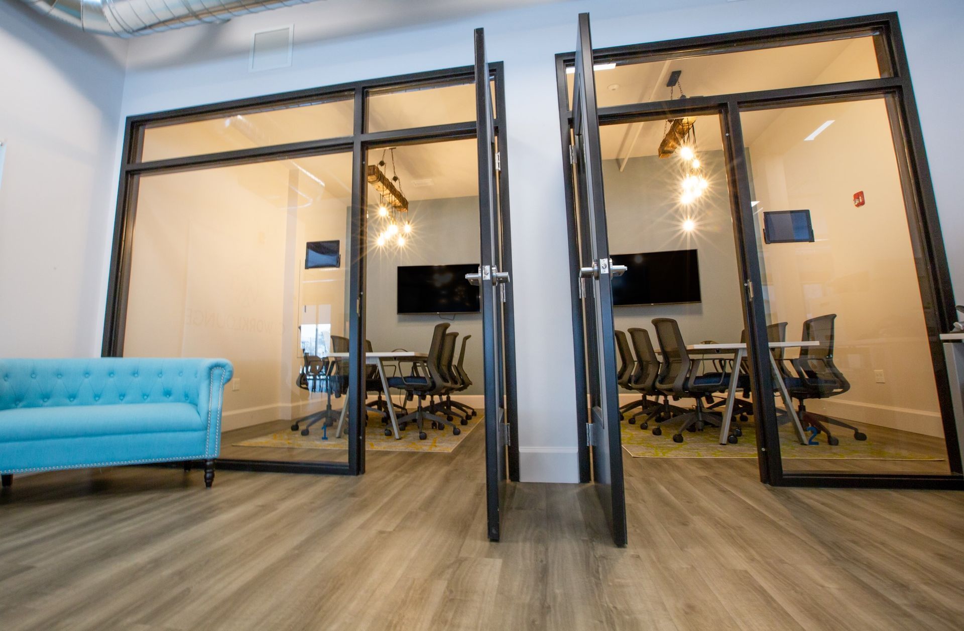 A conference room with a blue couch and chairs in it