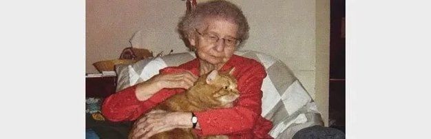 An old woman holding her cat