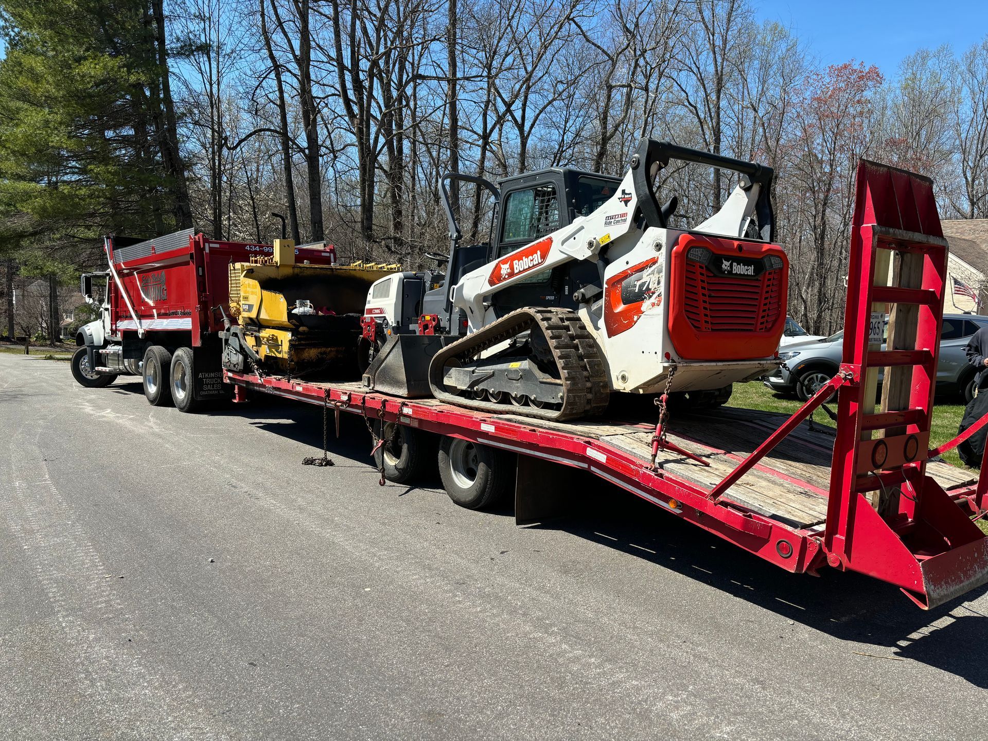 A skid loader loaded on to a flatbed