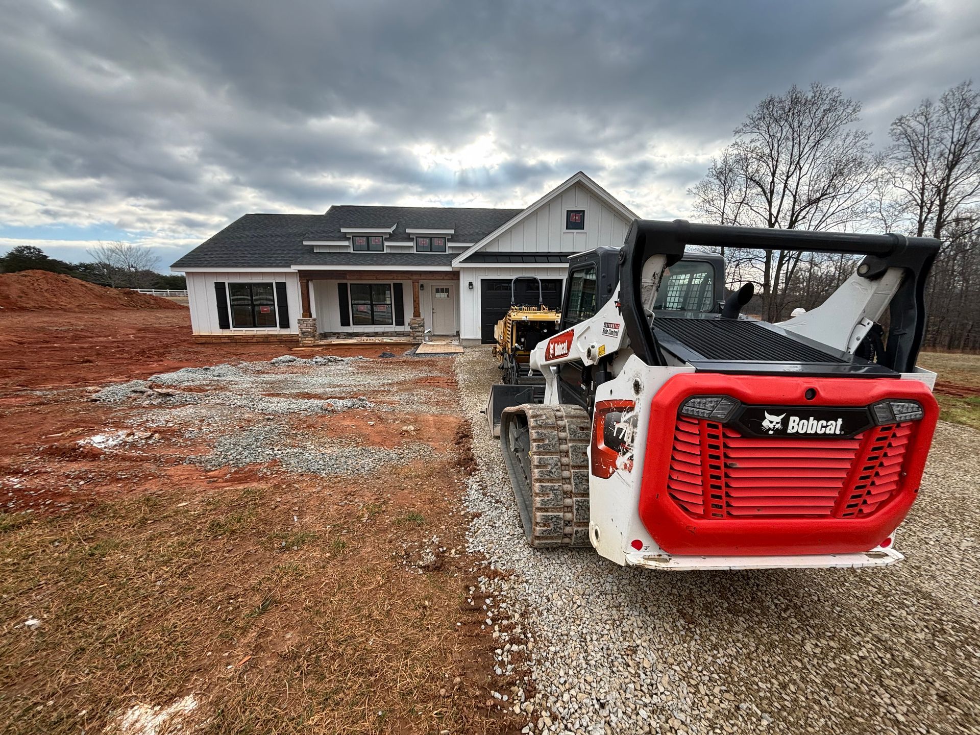 A skid loader in front of a construction site