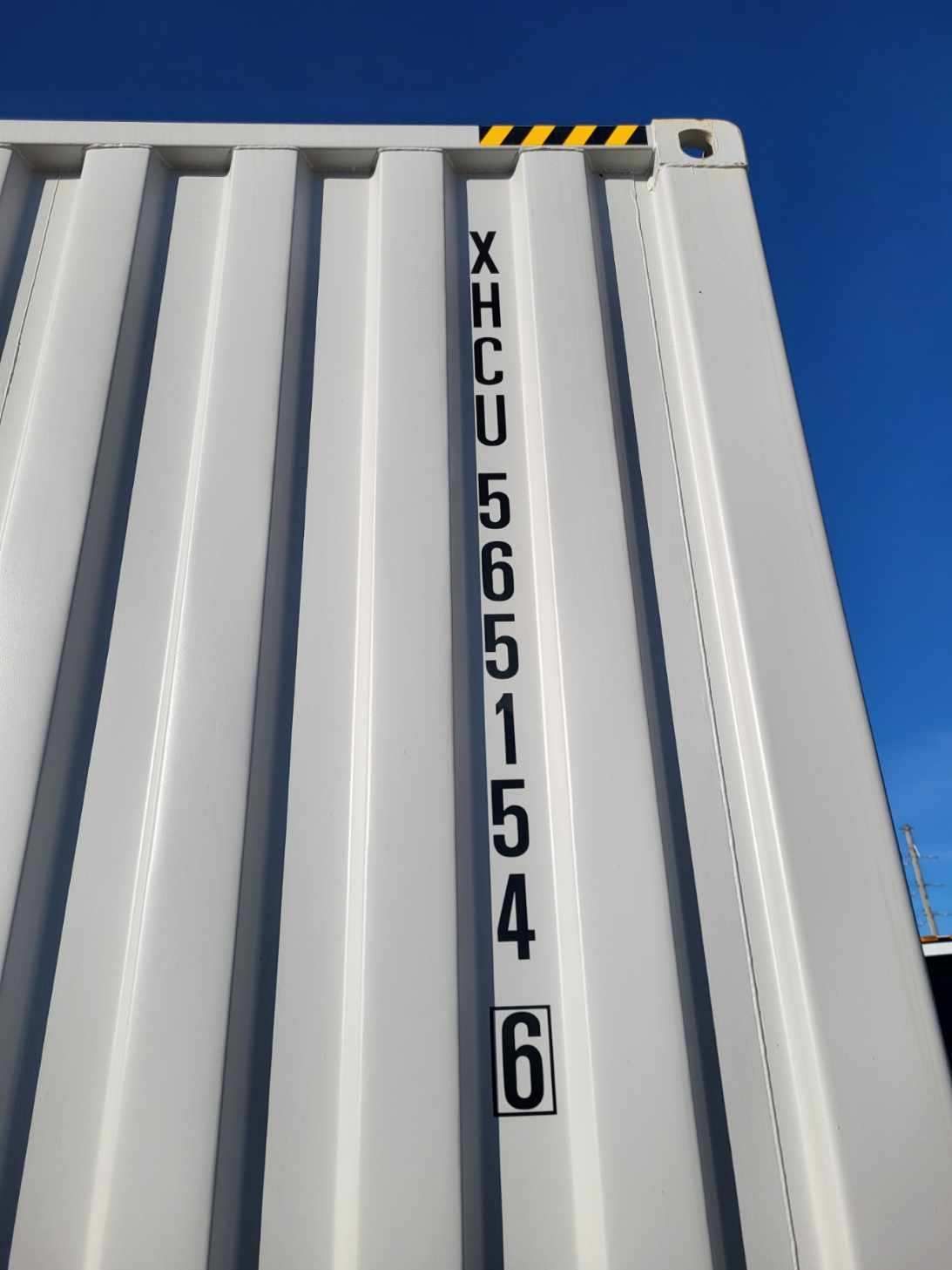 A white shipping container with the number 6 on it