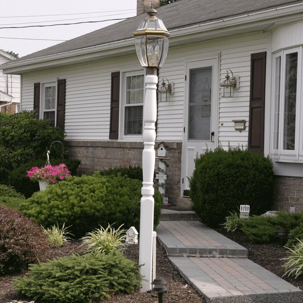 A white house with a lamp post in front of it
