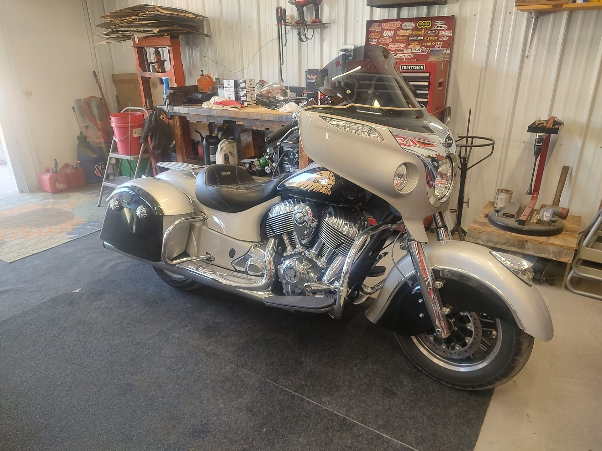 Silver and black Indian motorcycle in a garage.