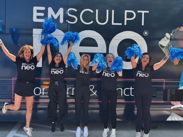 Five women jumping for joy in front of an 