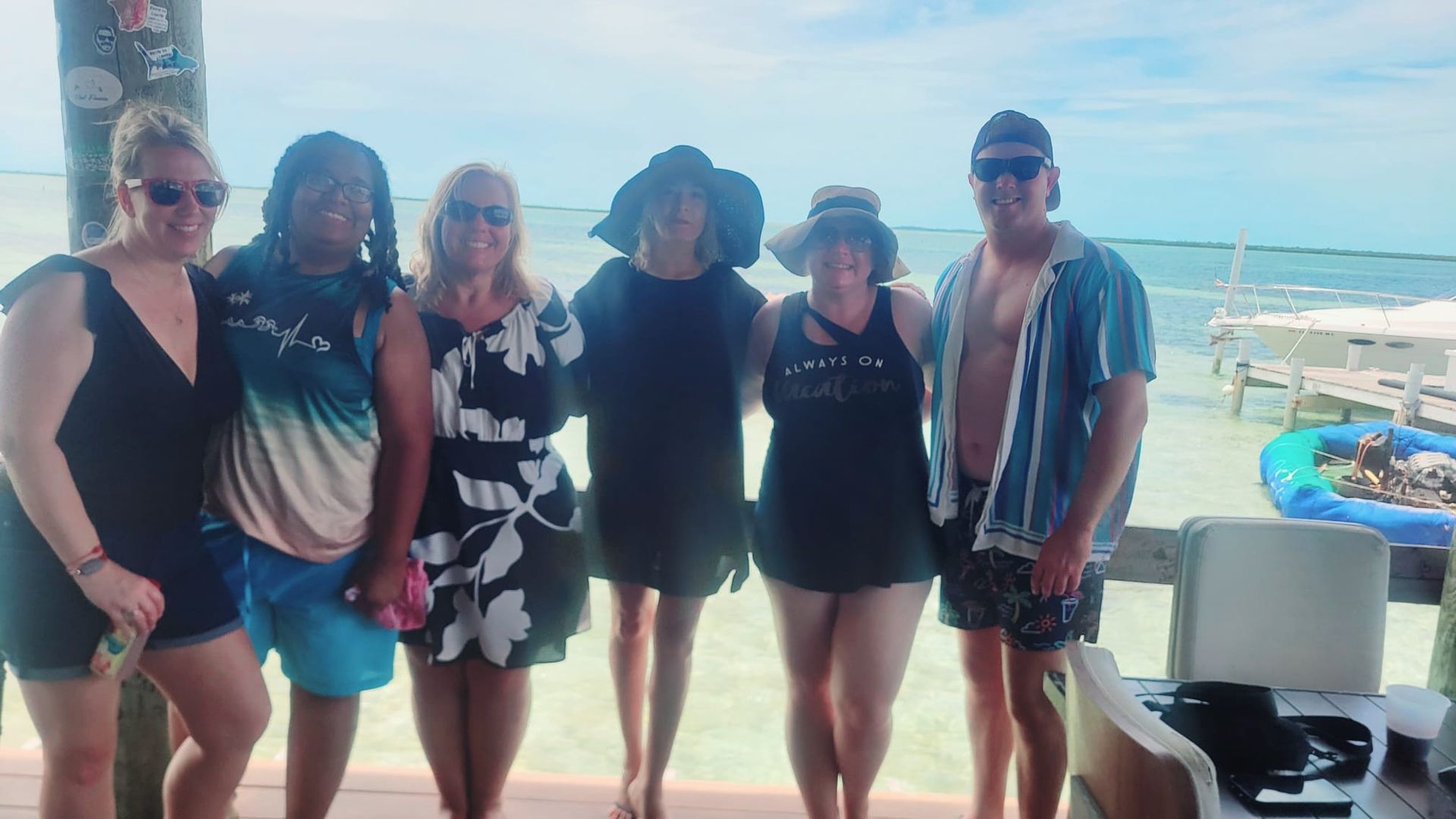A group of people are posing for a picture on the beach