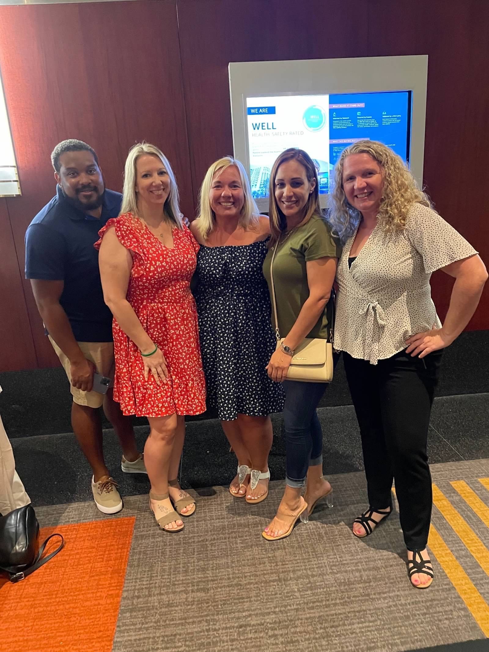 A group of people are posing for a picture in a room