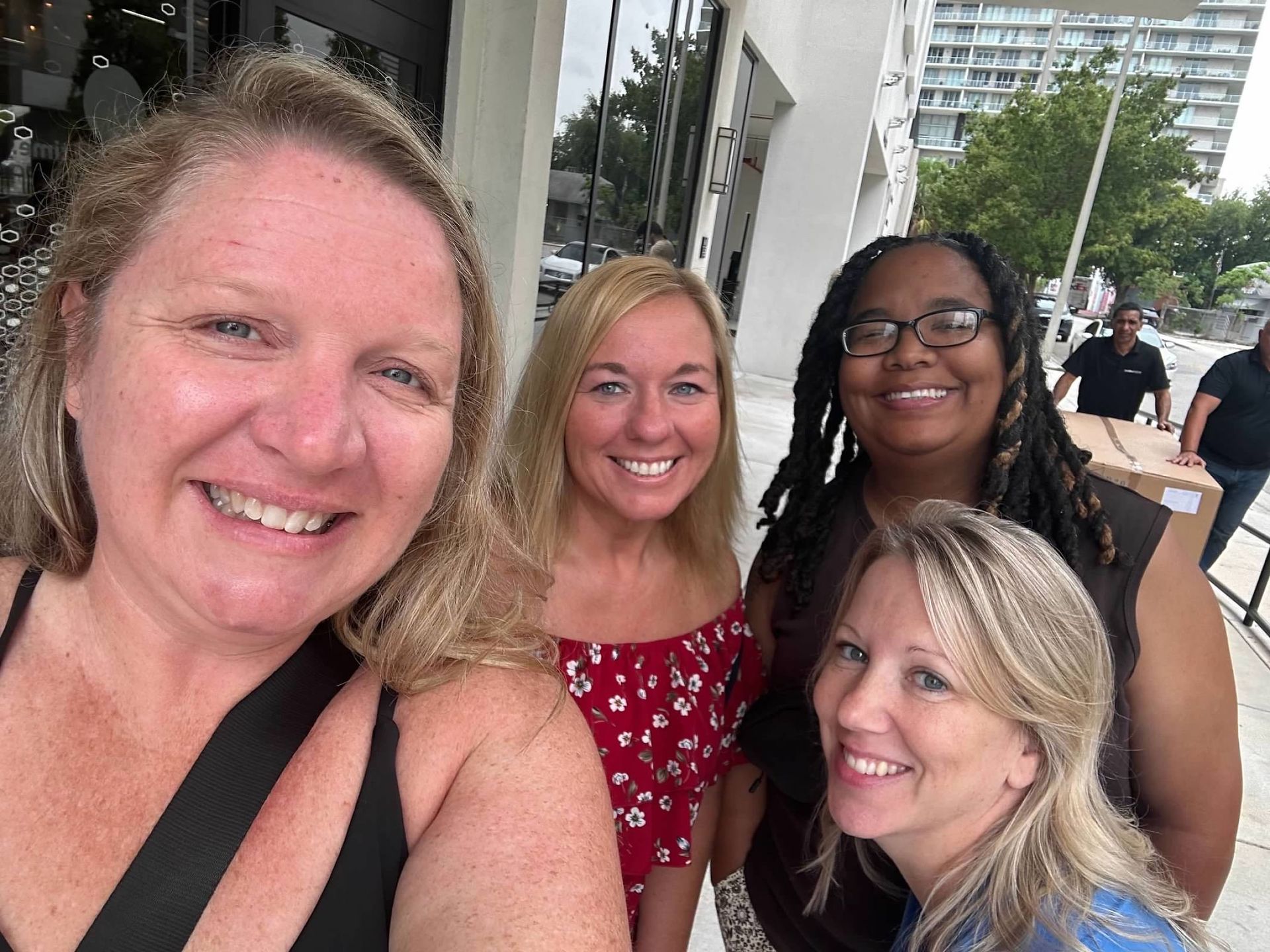 A group of women are posing for a picture together and smiling