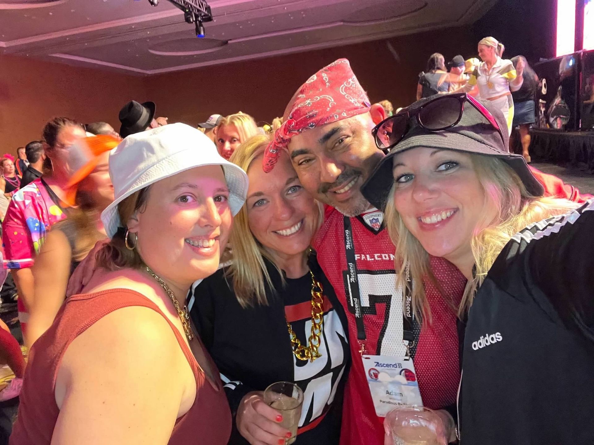 A group of people posing for a picture with one wearing a jersey