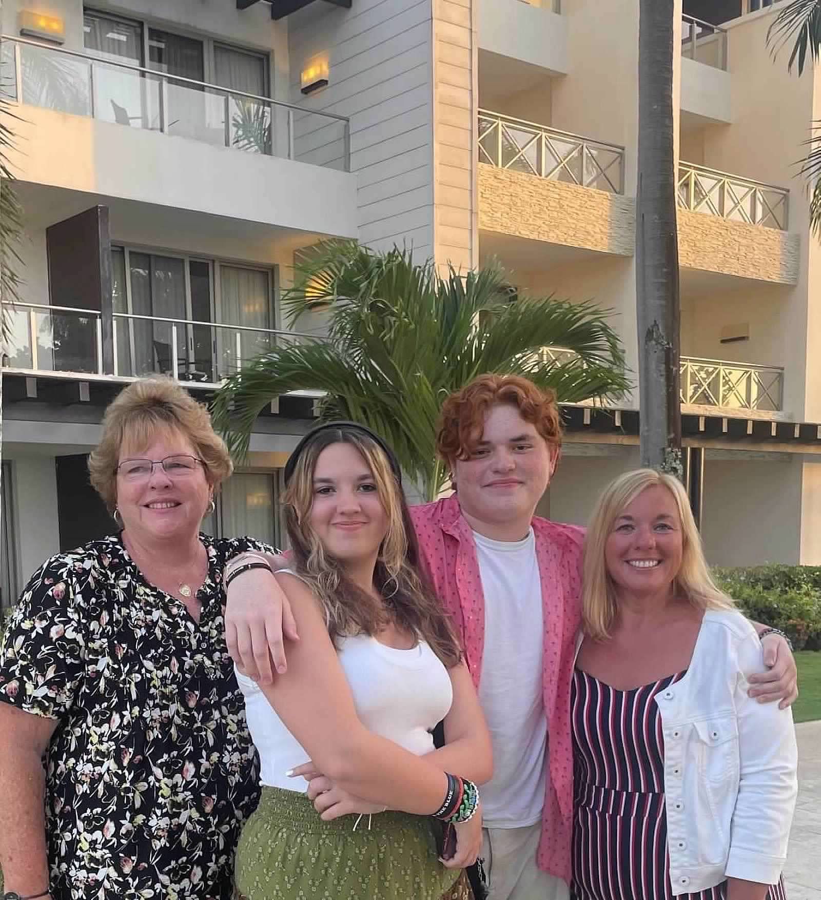 A group of people posing for a picture in front of a building