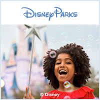A little girl blowing soap bubbles at disney parks