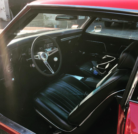 A red car with black seats and a steering wheel