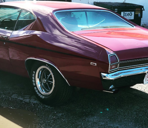 A red car with a bfgoodrich tire on it
