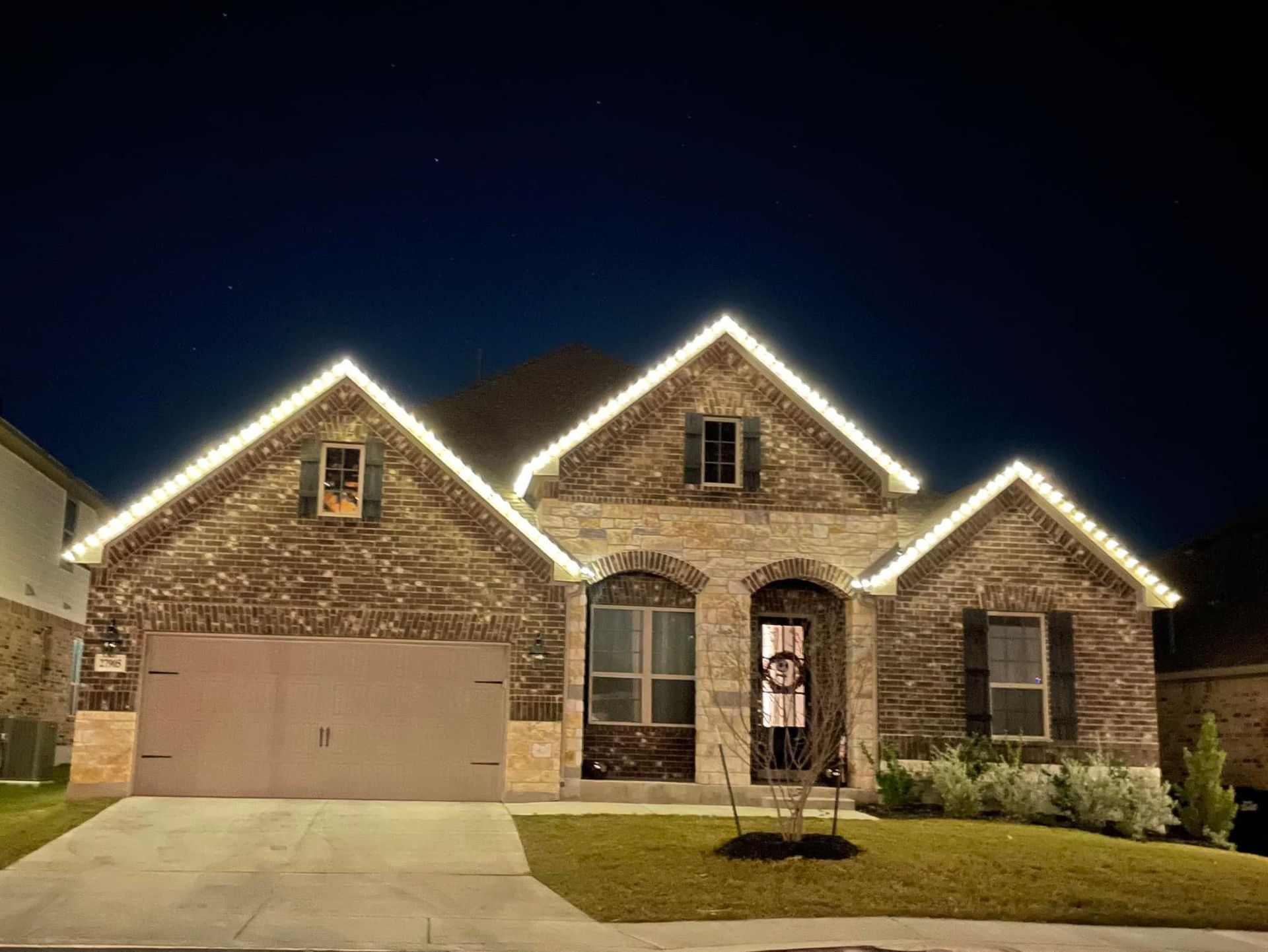 Beautiful house with a nice landscape with Christmas lights.