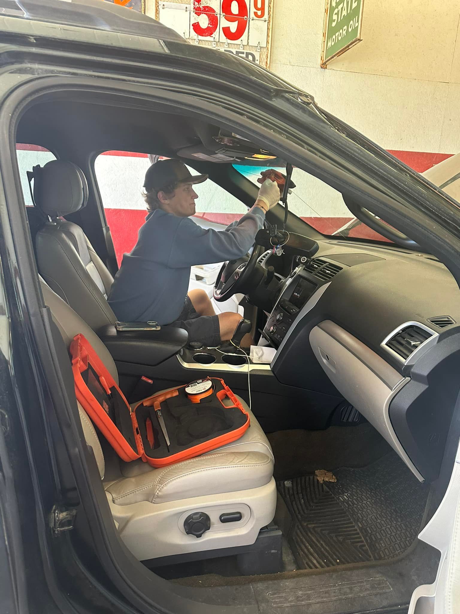 A man is sitting in the driver's seat of a car.