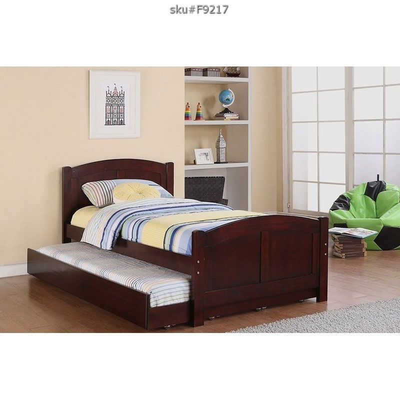 wooden trundle bed with striped bedding