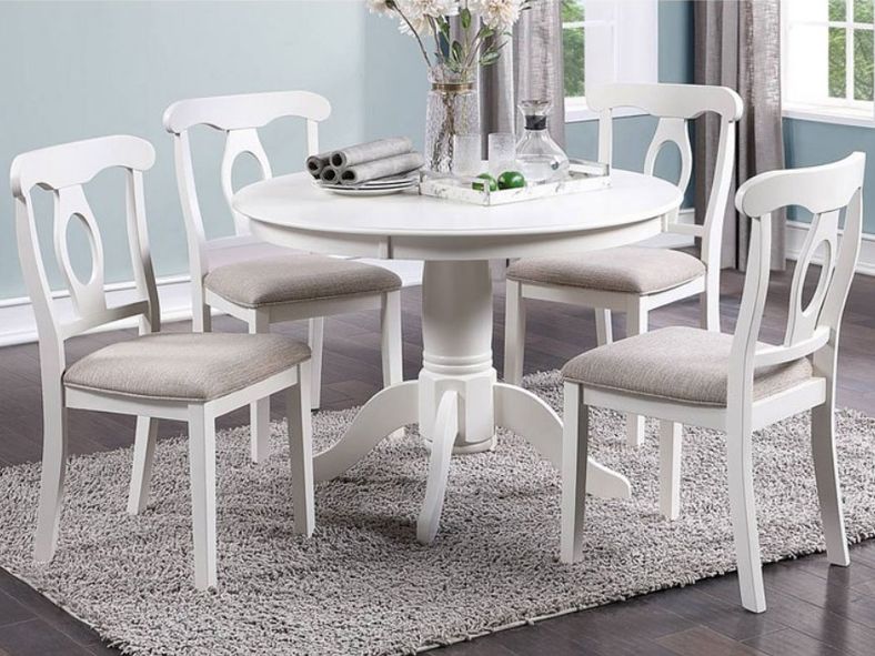 white round dining table and four chairs