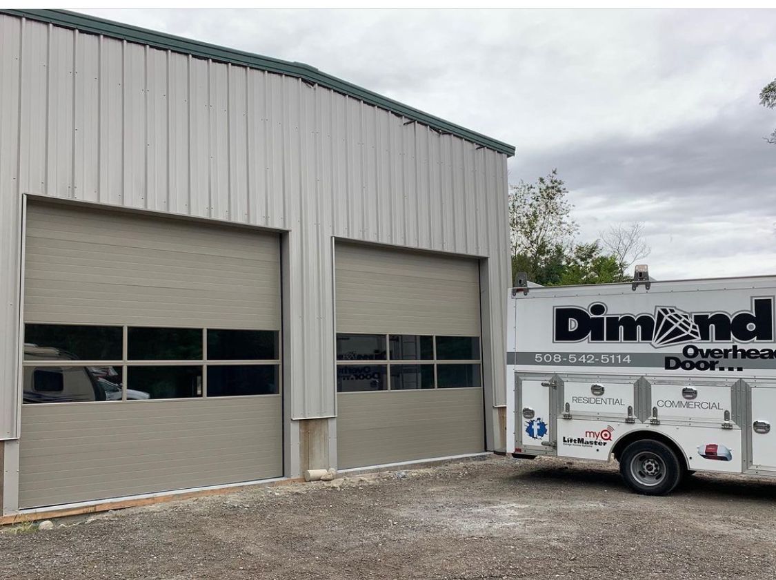 A truck is parked in front of a garage door