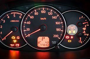 Learn more about Engine diagnotics Car dashboard with illuminated gauges and warning lights.