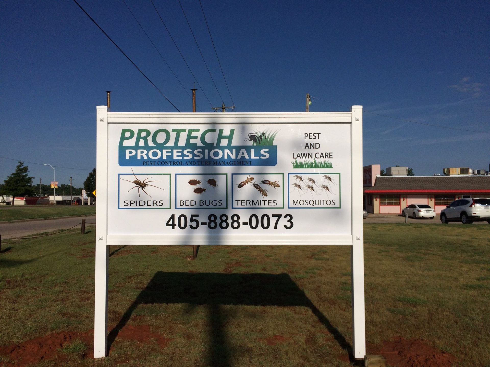 A white sign that says protech professionals on it