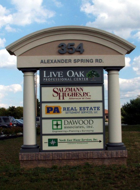 A sign for the alexander spring rd. live oak professional center
