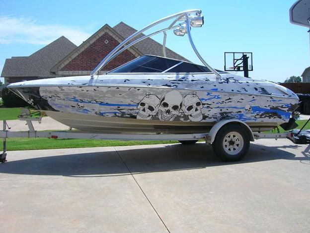 A boat with skulls painted on it is on a trailer