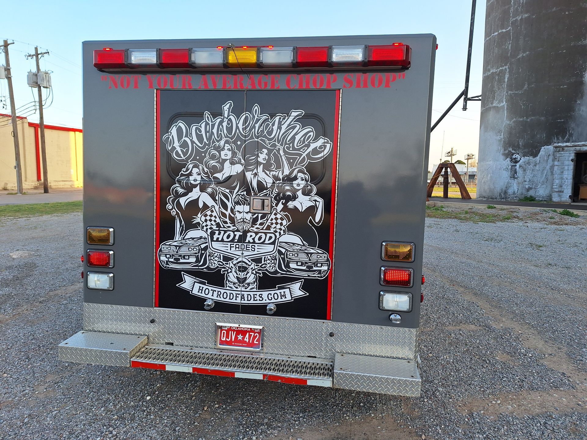 The back of a gray truck with a patchworks logo on it